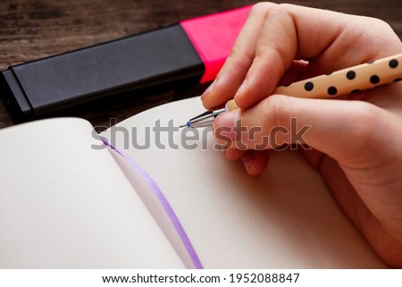pencils. hand, notepad. Child teenager plans to write with a mechanical pencil or pen in a notebook