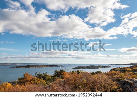 High-level view of the sea around islands of the Southern Gothenburg Archipelago, in Sweden, during a sunny day with blue sky and clouds. Archipelago of Gothenburg (Swedish: Göteborgs skärgård)
