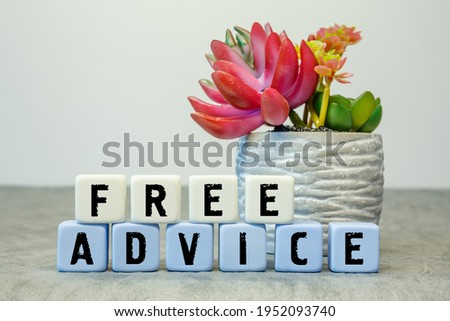 Soft cubes with the abbreviation FREE ADVICE with a flower on a white background
