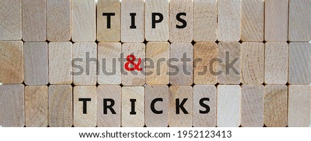 Tips and tricks symbol. Wooden blocks with words 'tips and tricks'. Beautiful wooden background. Business and tips and tricks concept, copy space.