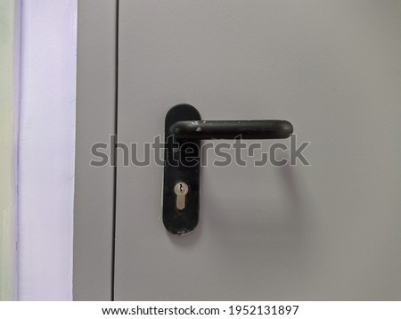 closed metal door with black handle photo