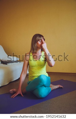 adult beautiful European Woman practicing home yoga. A series of yoga poses. cow head pose Gomukhasana healthy lifestyle concept, wellness self-care