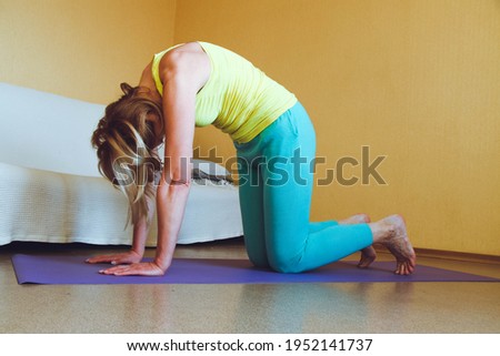 adult beautiful European Woman practicing home yoga. A series of yoga poses. Marjariasana cat cow pose healthy lifestyle concept, wellness self-care