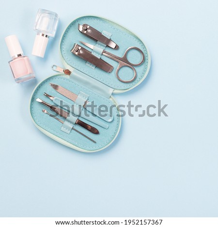 Manicure or pedicure set equipment, on a blue background, copy space, top view, square format