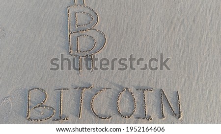 "Bitcoin" word is written on the beach sand
