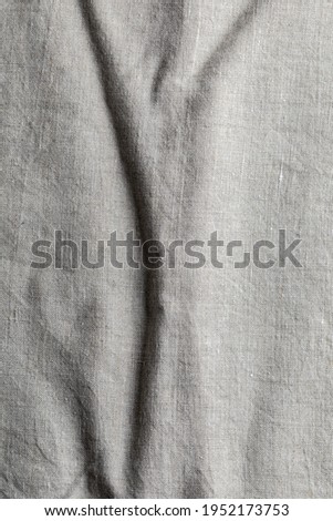 Delicate linen fabric texture. With various folds and wrinkles.Macro close-up. With copy space.