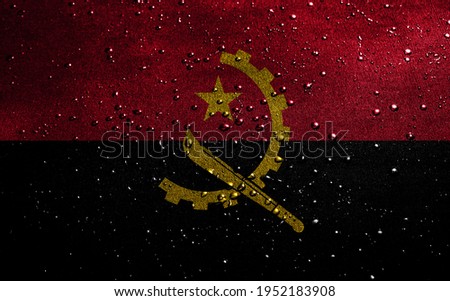Background with flag of Angola with drops