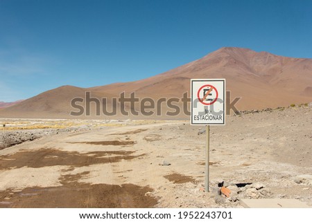 No parking sign in the desert with a mountain