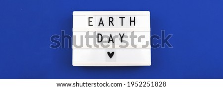 Celebration banner for Earth Day 22th april, blue background and lightbox with lettering