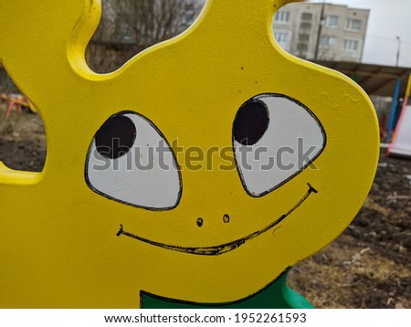 large wooden and yellow snail made of wood in the playground