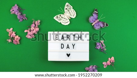 Earth day green concept with lettering on a lightbox, eco friendly world backcground photo