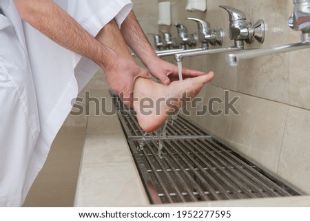 A Muslim takes ablution for prayer. Islamic religious rite Royalty-Free Stock Photo #1952277595