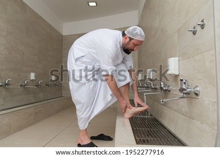 A Muslim takes ablution for prayer. Islamic religious rite Royalty-Free Stock Photo #1952277916