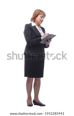 Photo of a thinking mature business woman holding clipboard and pen