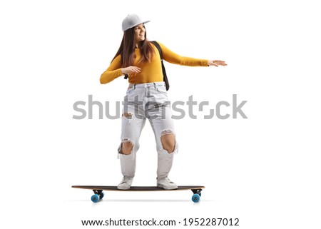 Full length shot of a cool female skater riding a longboard isolated on white background    