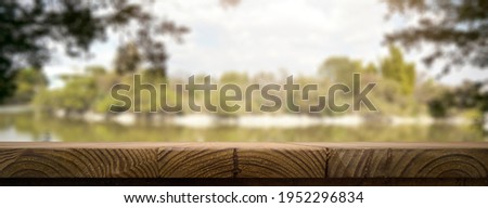 Empty wooden rustic table in the countryside on a beautiful fall afternoon