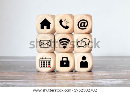 Online shopping or e-commerce concept with online business icons on wooden cubes against white background.