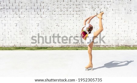 Teenage girl in elegant costume practicing figure skating on four wheels. Exercise the basket or diamond
