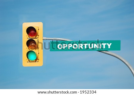 Green traffic light with the word opportunity written on the sign.
