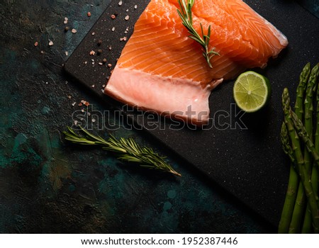 Fresh salmon fillet with rosemary and asparagus and lime. Top view. seafood. High resolution
