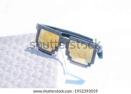 Golden lenses pixel 8bit sunglasses design shoot in a summer day closeup.Thug life model. Selective focus