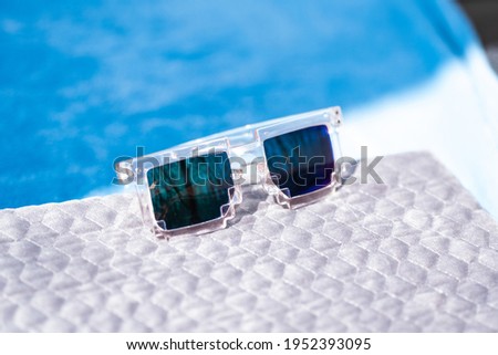 Pixel sunglasses design with green lenses shoot in a summer day closeup. Selective focus