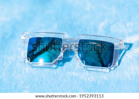 Pixel sunglasses design with green lenses shoot in a summer day closeup. Selective focus