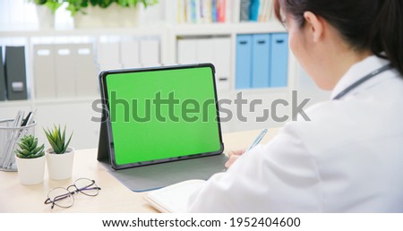 telemedicine concept - asian female doctor use green screen tablet pc to meeting with patient and giving advice