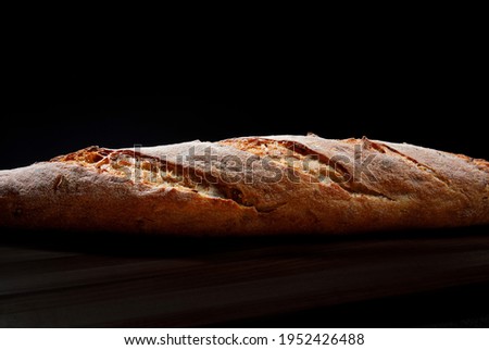 Baguette close-up. Baguette side view. Art bread. Royalty-Free Stock Photo #1952426488