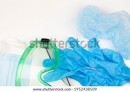 protective clothing set for the doctor. medical gloves, mask, glasses, hat.