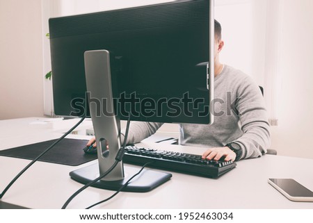 The man is working with pc in the office