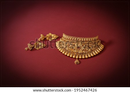 Indian traditional Jewelry in gold Royalty-Free Stock Photo #1952467426