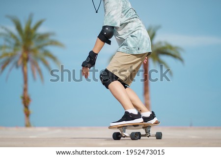 Hello Summer Surfers people Asian having fun with surfboards or surf skate around city streets background on a summer day. Free relax lifestyle and millennial trend concept