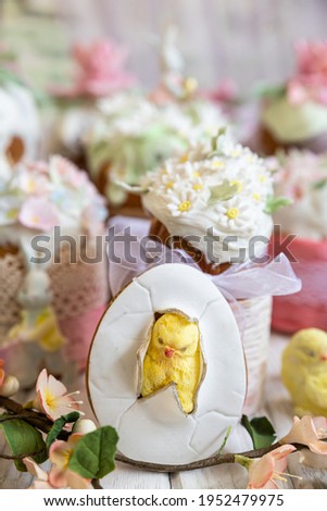 Easter composition with orthodox sweet breads or kulich decorated with white sugar icing and mastic flowers, light background. Traditional Orthodox cake. Holiday concept.