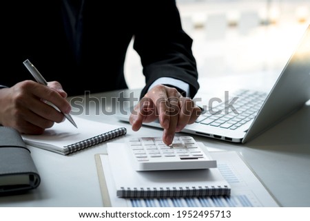 accountant or banker making calculations. Savings, finances and economy concept. Royalty-Free Stock Photo #1952495713