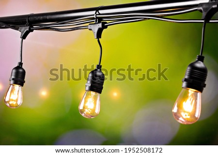 light bulbs on the balcony against the background of green grass