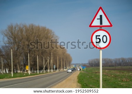 Road signs speed limit 50 km per hour. The road turns left raw footage