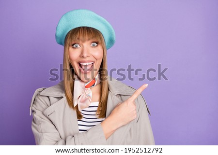 Photo of lady indicate finger empty space open mouth wear blue beret scarf coat isolated violet color background