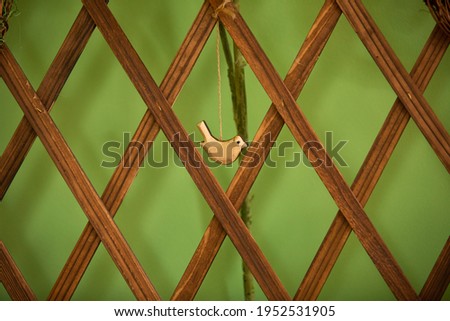 green background with wood bird in a center Royalty-Free Stock Photo #1952531905
