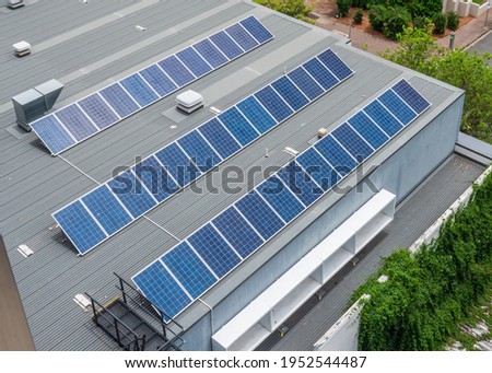 Solar panels on the roof of a building. This technology uses sunlight as a source of energy to generate direct current electricity.  This system is also known as a photovoltaic (PV) module. Royalty-Free Stock Photo #1952544487