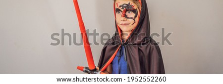 Boy with a picture of a dragon on his face for party or halloween BANNER, LONG FORMAT