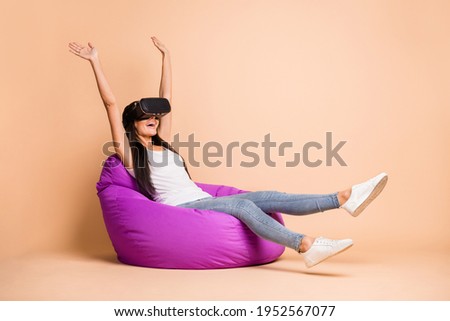 Full size profile photo of hooray brunette girl sit pouf with 3d eyewear wear top jeans isolated on beige background