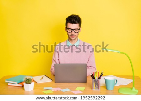 Photo of young serious man study learn programmer courses type laptop watch webinar isolated over yellow color background