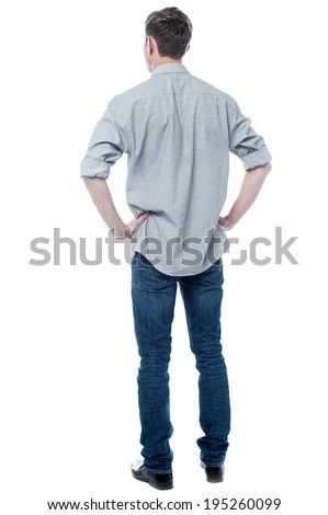 Back pose, full length shot of a young man looks ahead Royalty-Free Stock Photo #195260099
