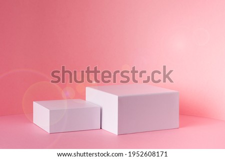 White square podiums for presentation cosmetic, accessories and produce on sunny bright pastel pink background with sun flare, copy space. Fashion fresh spring showcase.