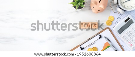 Top view of reading the overview and calculating, paying tax concept on marble white table. Royalty-Free Stock Photo #1952608864