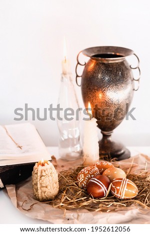 candles, paited eggs, willow branches and bible. easter at home. Easter theme