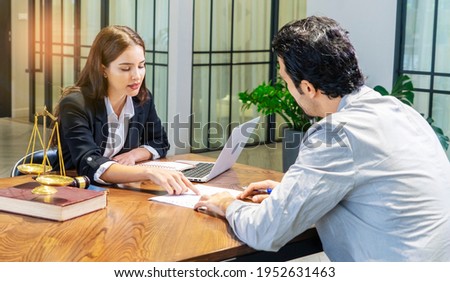 Lawyer gives legal advice and talks to her clients for advice on the rules and regulations that must be followed at the Office of Legal Counsel.  Royalty-Free Stock Photo #1952631463