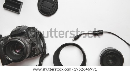 modern dslr camera, photo equipment and copy space over white table background