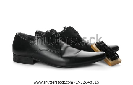 Black men's shoes and brush on white background. Footwear care